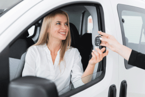 close-up-shot-with-smiley-woman-receiving-car-key
