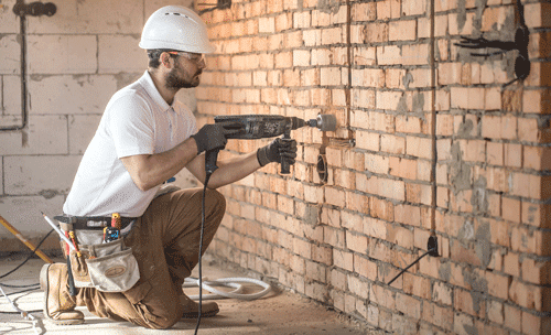 handyman-uses-jackhammer-installation-professional-worker-construction-site-concept-electrician-handyman